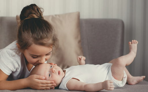 Toddler meeting newborn baby